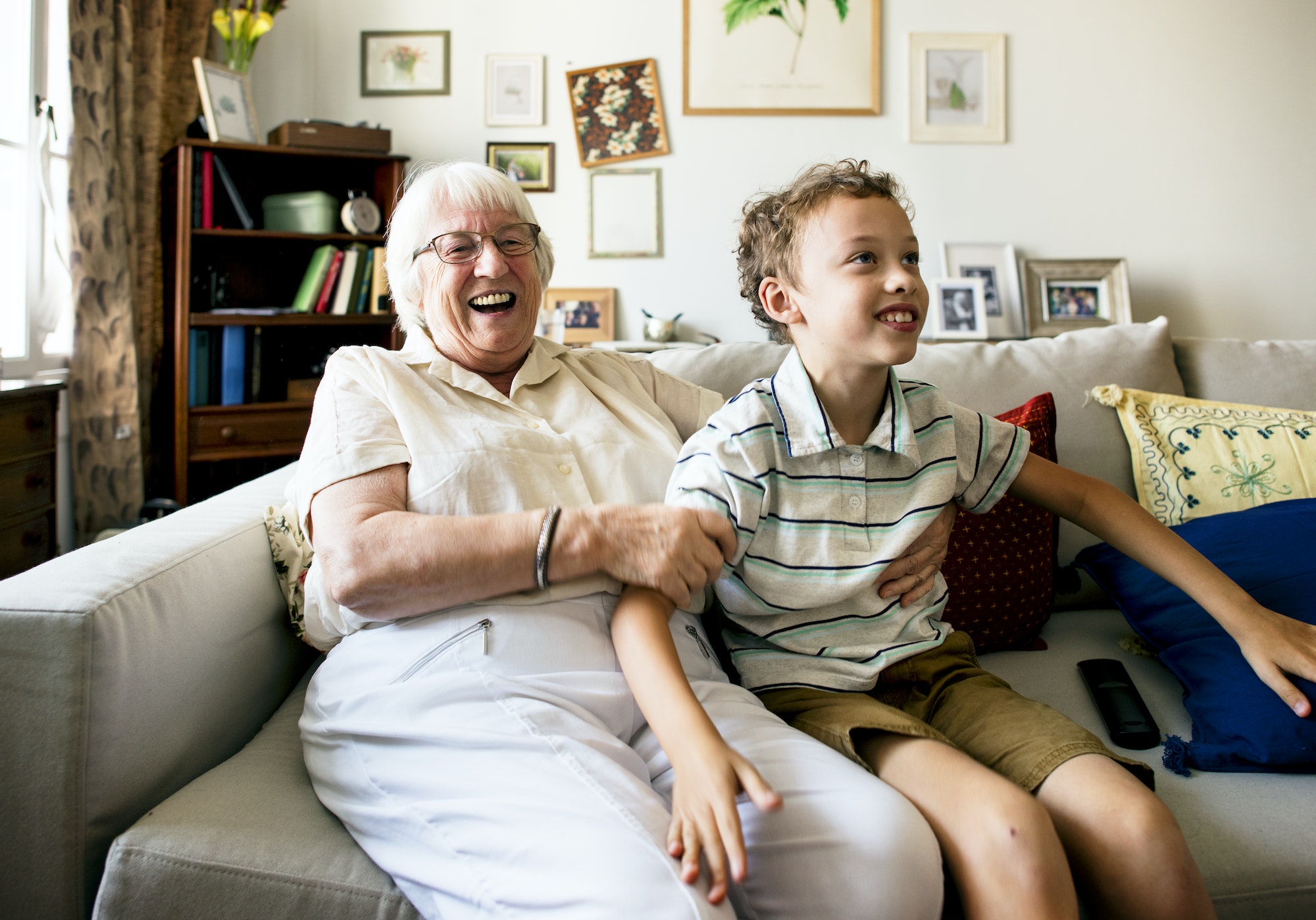 Grandma and grandson sitting on the sofa together - not an actual client with removable dentures