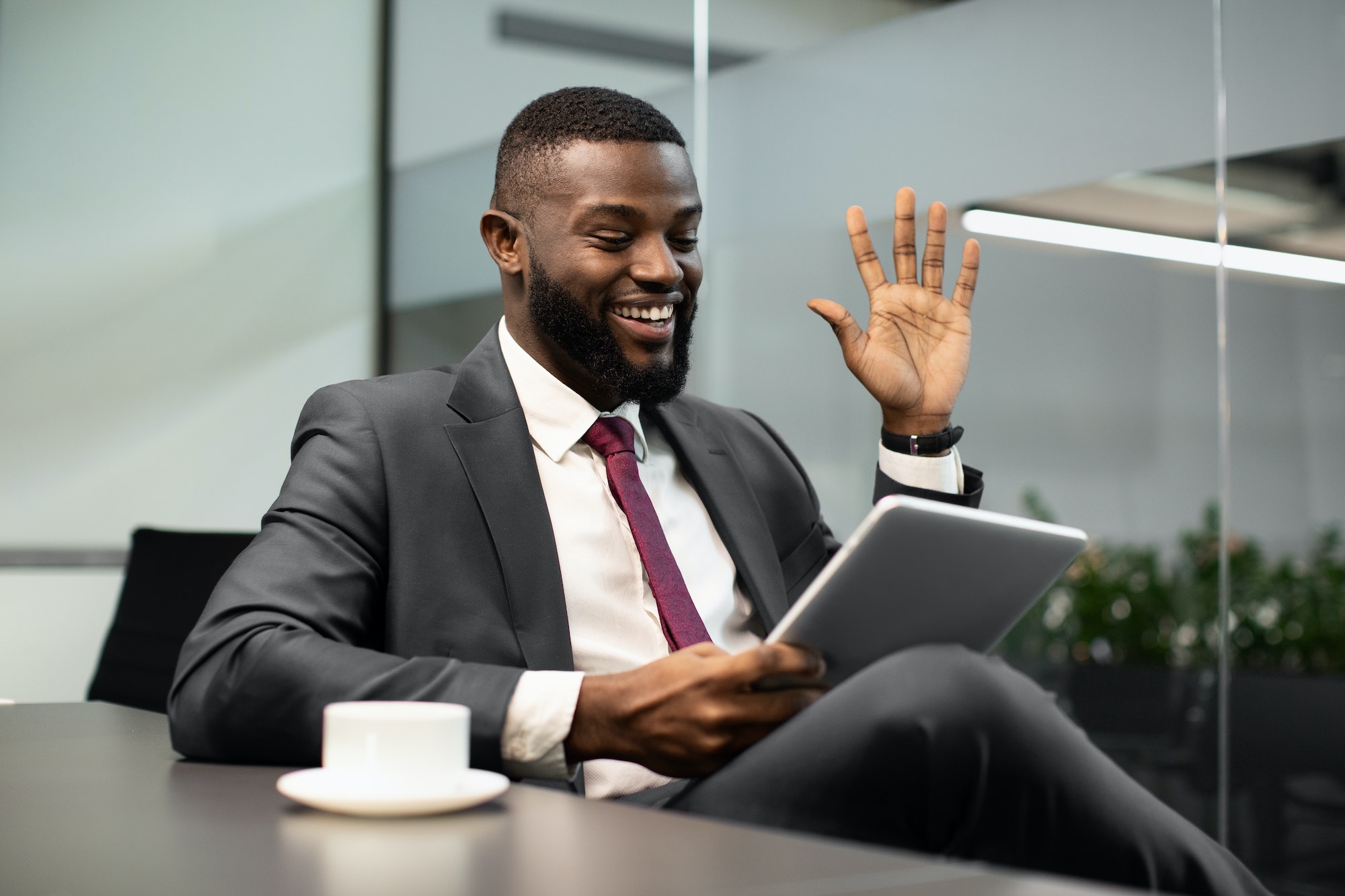 Happy black businessman having video chat, using digital tablet TranscenDental Smiles offers ROOT CANAL TREATMENT