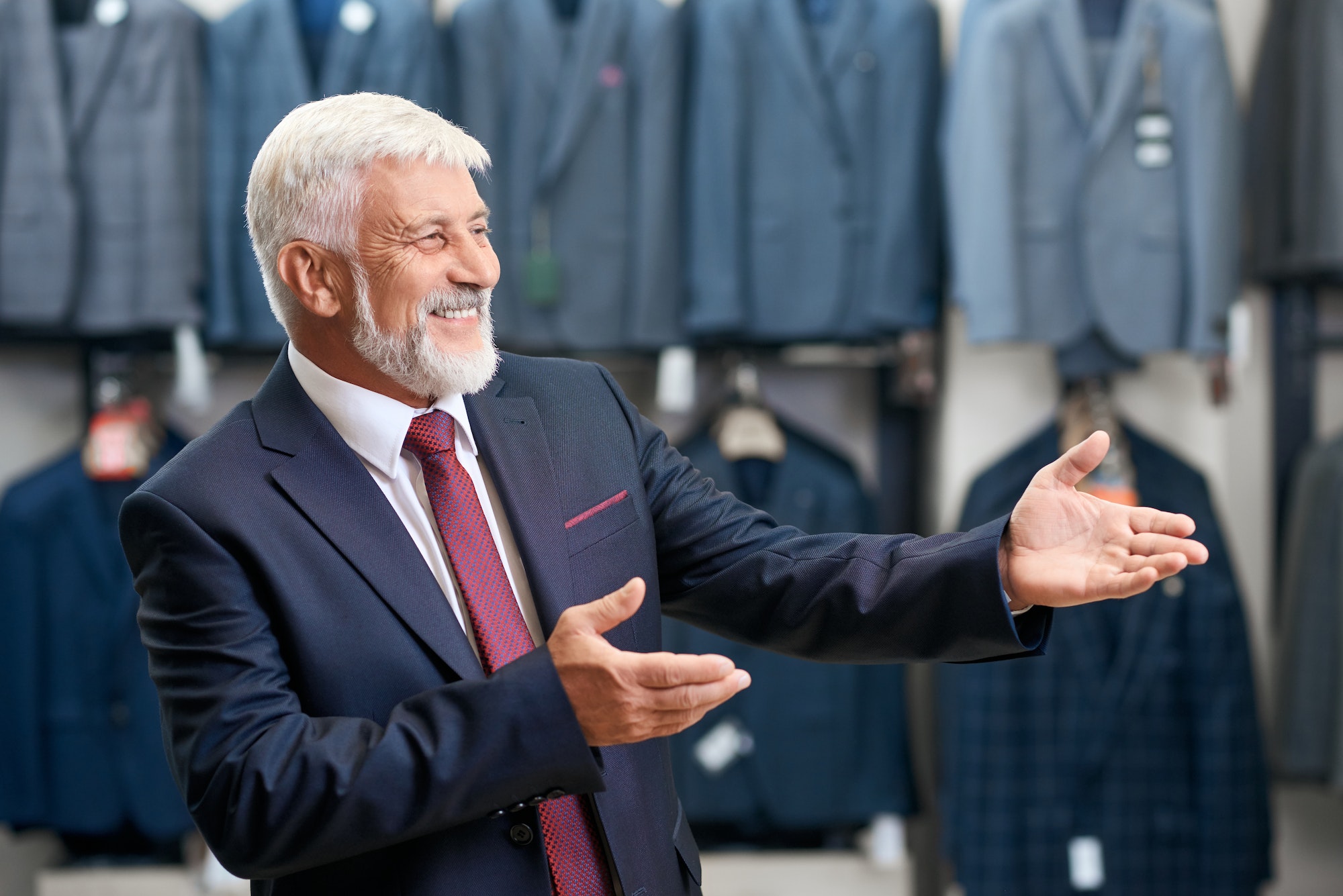 Older man smiling choosing costumes in store Select TranscenDental Smiles Texas as your restorative dentistry service